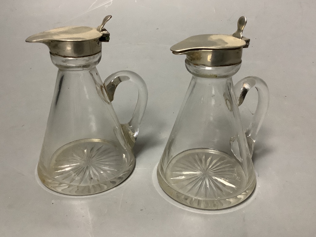 A pair of George V silver mounted glass whisky tot jugs, S. Blanckensee & Sons Ltd, Birmingham, 1932/3, height 10.3cm.